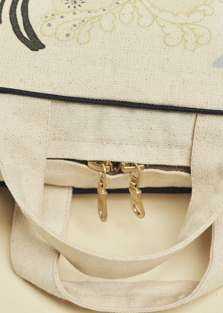 Gold zip and handles on cotton case with hand illustrated 'Forivor' motif.