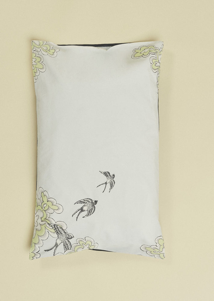 Pale blue organic cotton pillowcase featuring a ring of hand illustrated swifts.