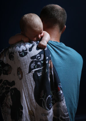 Father and baby with hand illustrated woodland scene baby muslin.