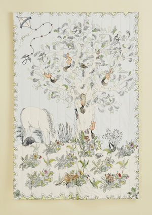 Organic cotton, quilted hand illustrated daytime woodland scene blanket.