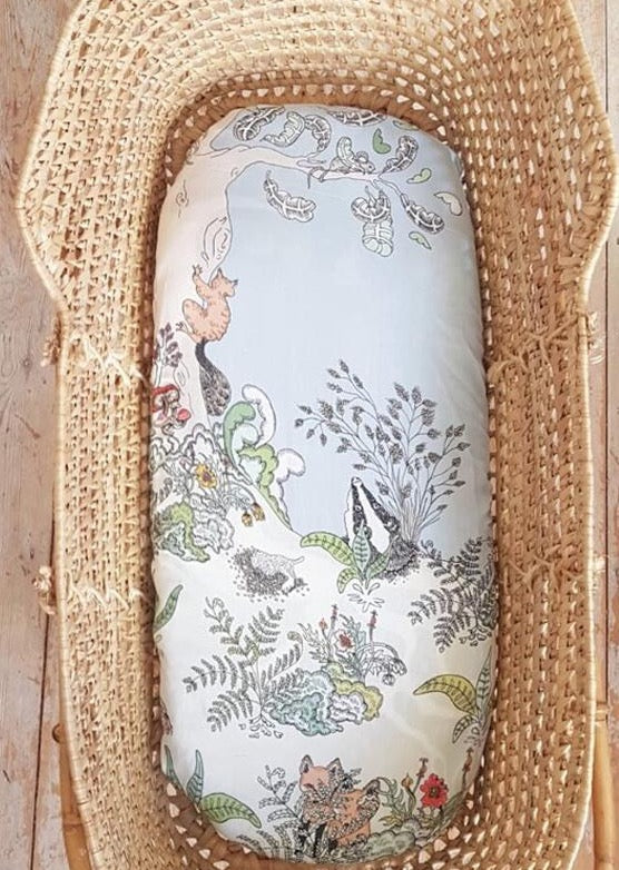 Moses basket with hand illustrated woodland scene fitted sheet.