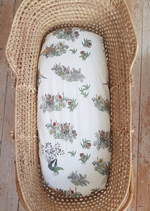 Moses basket with hand illustrated white 'Hidden Foxes' fitted sheet.