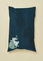 Nighttime blue pillowslip featuring hand illustrated white rabbit.